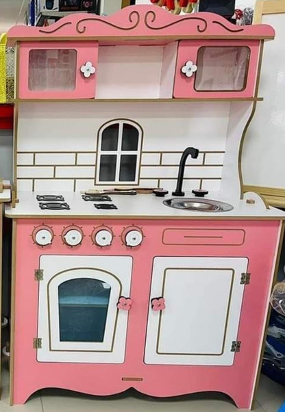 wooden pink kitchen set with sink oven and closets